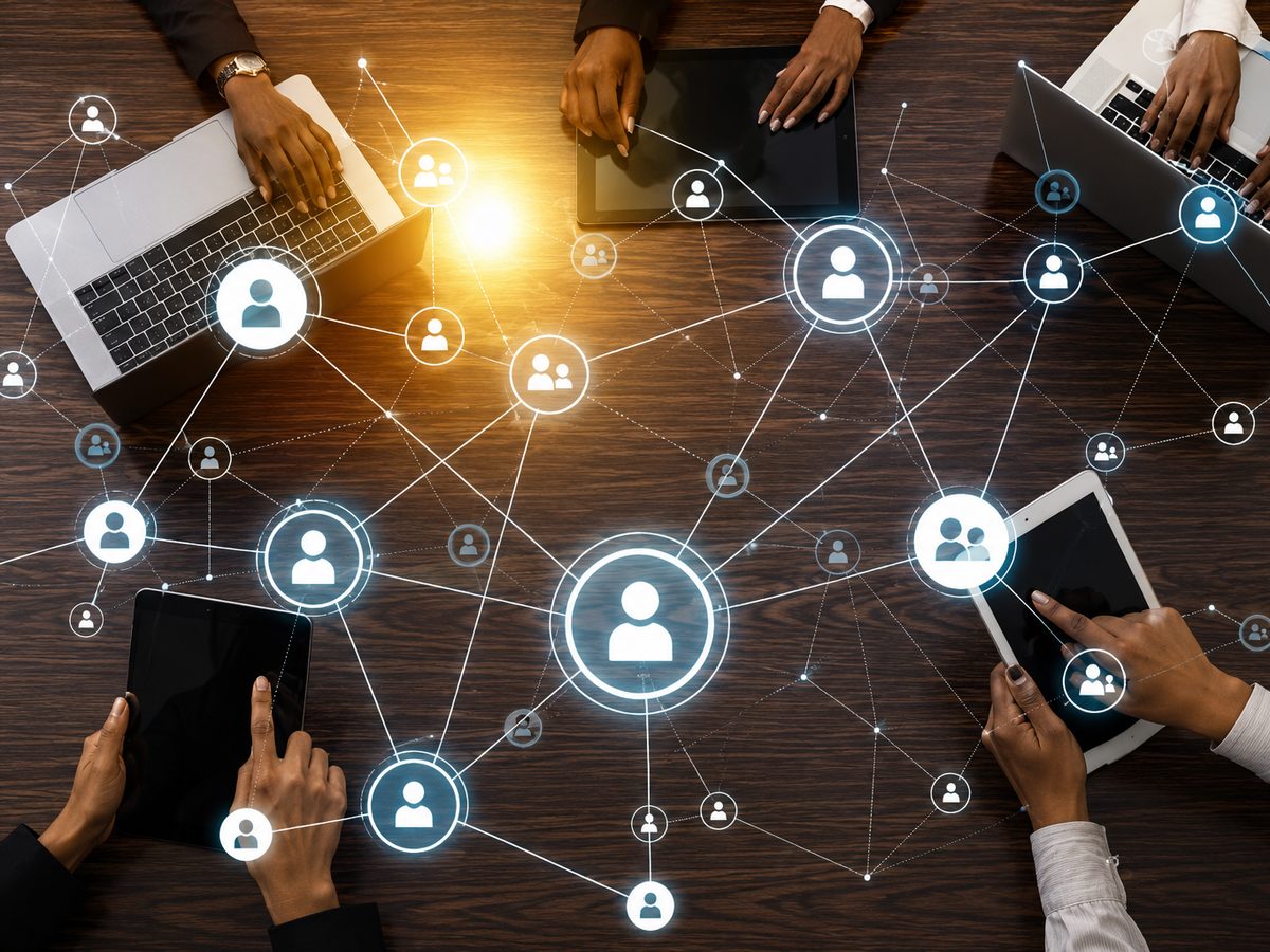 Team collaborating across devices, connected by a network of client relationships